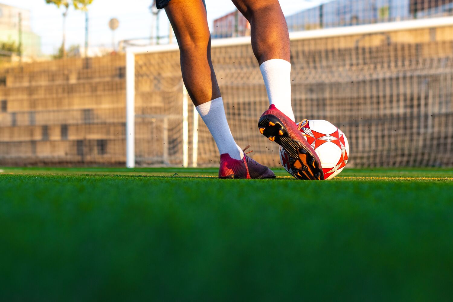 closeup shot of a football player's feet running with the ball in the goal area
